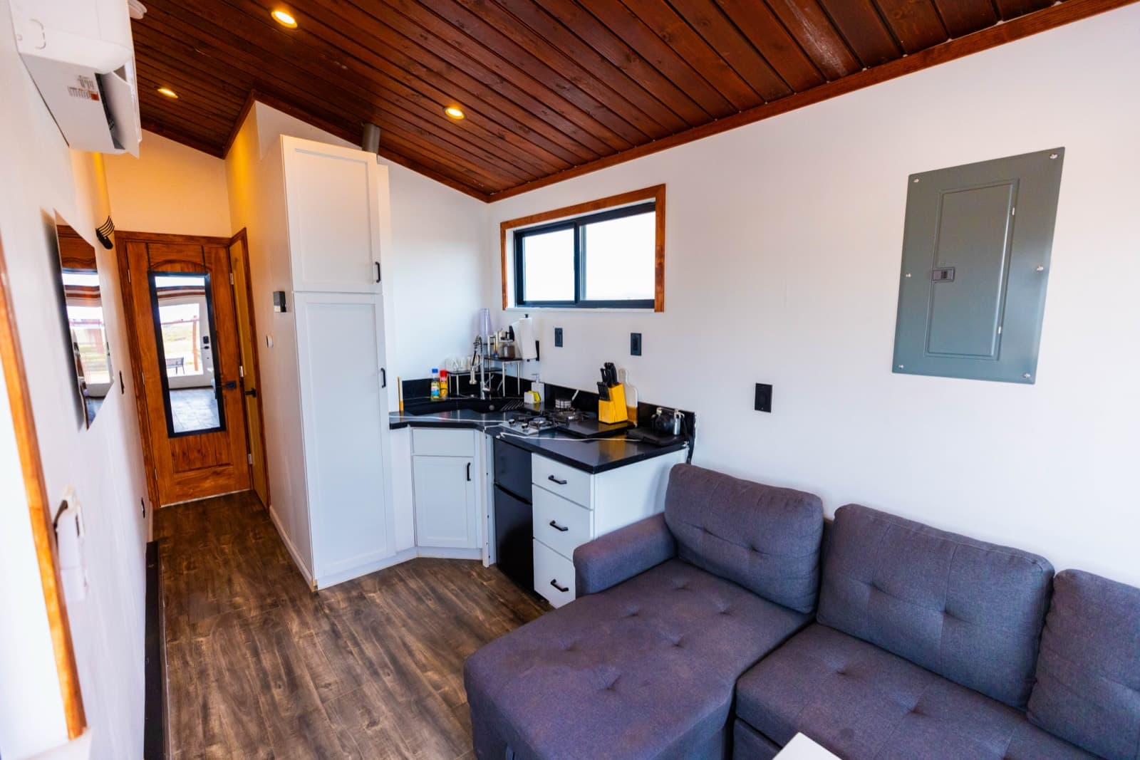 Kitchen with white cabinets, black counters and a stove