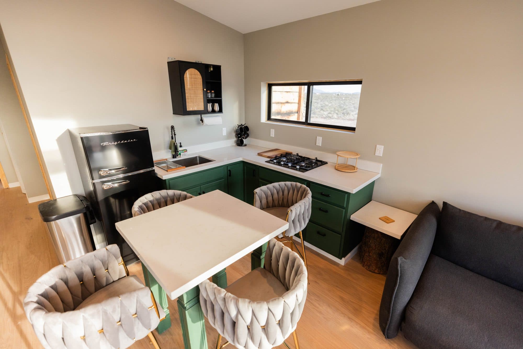 Kitchen with green cabinets, a gas stove and a dining table